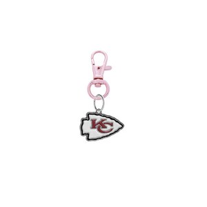 May include: A pink metal keychain with a silver charm featuring the Kansas City Chiefs logo. The logo is a white arrowhead with a red "KC" inside.