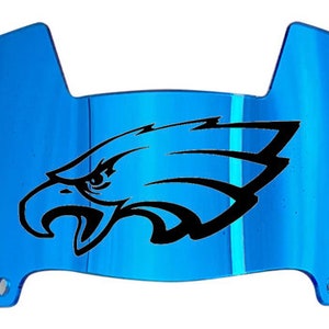 May include: A blue plastic football helmet visor with a black eagle graphic.