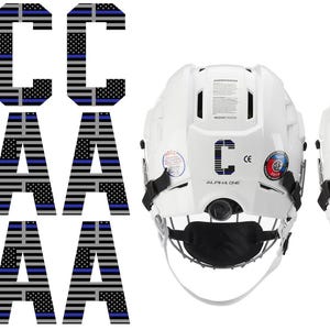 May include: White hockey helmets with the letters "C" and "A" on the back, along with matching letter decals. The decals and letters feature a design of the American flag with a blue stripe.