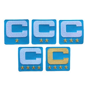 May include: Five embroidered patches with a light blue background and a white or gold letter "C". Each patch has a different number of gold stars below the letter. The patches are square.