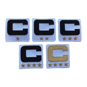 May include: Five embroidered patches with a light blue background. Each patch features a black or gold letter "C" and gold stars. The patches vary in the number of stars, ranging from one to four.