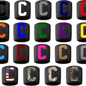 May include: A set of 16 wristbands with the letter "C" in various colors and patterns, including black, white, gray, orange, blue, green, purple, yellow, red, pink, brown, and camouflage.