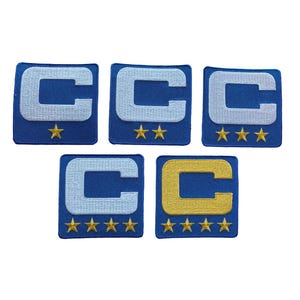 May include: Five embroidered patches featuring a capital letter "C" in white or gold, set on a blue square background. Each patch has a different number of gold stars below the letter, ranging from one to five stars. The patches are arranged on a white background.