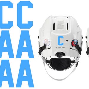 May include: White hockey helmets with black face masks and chin straps. One helmet has a blue "C" and the other has a blue "A" on the back. The word "ALPHA ONE" is printed below the letters. Several blue "C" and "A" letters are also displayed.