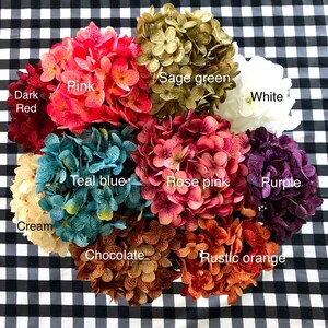 May include: Assortment of 10 faux hydrangea flower heads in various colors, including pink, sage green, white, cream, teal blue, rose pink, purple, chocolate, and rustic orange.
