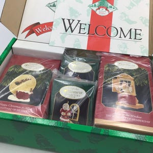 May include: A Hallmark Keepsake Ornament Collector's Club box containing three individually wrapped ornaments. The box includes a Welcome card and boxes labelled Happy Christmas to All, Collector's Club, and Away to the Window, all dated 1997.