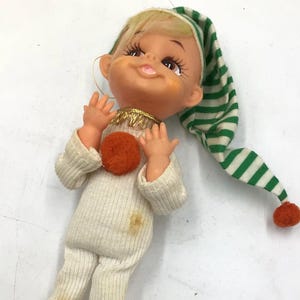 Japan vintage pixie elf in pajamas Christmas ornament pixie rubber face elf 1960’s Christmas decor green stripe cap and slippers. Kitschy
