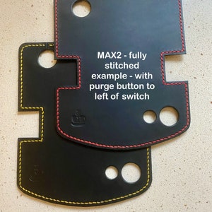 May include: Two black leather covers with yellow and red stitching. The top cover has the text "MAX2 - fully stitched example - with purge button to left of switch".