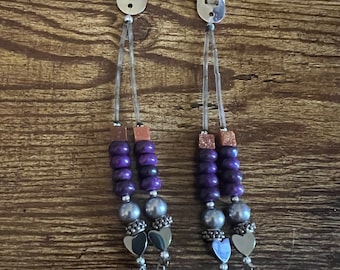 hair snap clips with purple beads and silver wing charms.