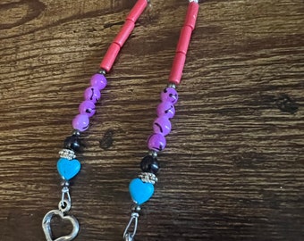 silver hair clips with beads and heart and arrow charms.