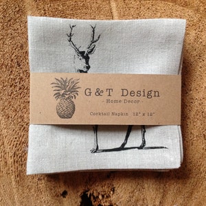 May include: Set of four linen cocktail napkins with a black and white deer print. The napkins are packaged with a brown label that reads "G&T Design - Home Decor - Cocktail Napkin 12" x 12" ".