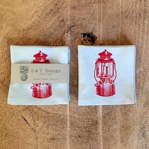 May include: Set of two red and white cotton cocktail napkins featuring a vintage lantern design. The napkins are 12 inches by 18 inches and are labeled "G&T Design - Home Decor".