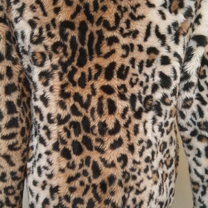 May include: A brown, black, and white faux fur jacket with a leopard print pattern.