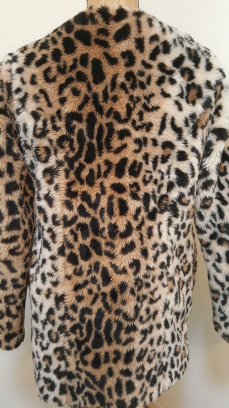May include: A brown, black, and white faux fur jacket with a leopard print pattern.
