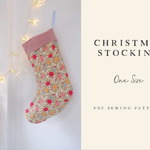 May include: A PDF sewing pattern for a Christmas stocking. The stocking is made of a floral fabric with a red and white gingham cuff. The pattern is one size.