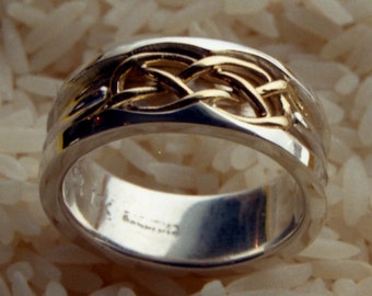 Mans wedding band made from Sterling Silver and 22k yellow gold tied into a genuine Celtic knot.