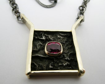 Hammer Forged 18k gold and reticulated oxidized sterling silver Ruby pendant on hand made chain.