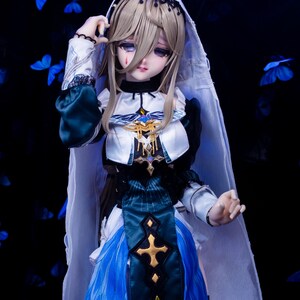May include: A detailed doll with long blonde hair, wearing a white and blue dress with gold accents. The doll has a veil and is set against a dark background with blue butterfly accents. The doll's expression is somber.