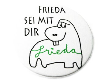 Button, magnet, pocket mirror or bottle opener.  Frieda.