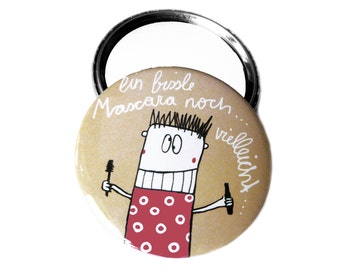Button, magnet, pocket mirror or bottle opener. A little mascara perhaps