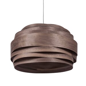May include: A brown wooden pendant light with a layered, woven design. The light is suspended from a thin cord.