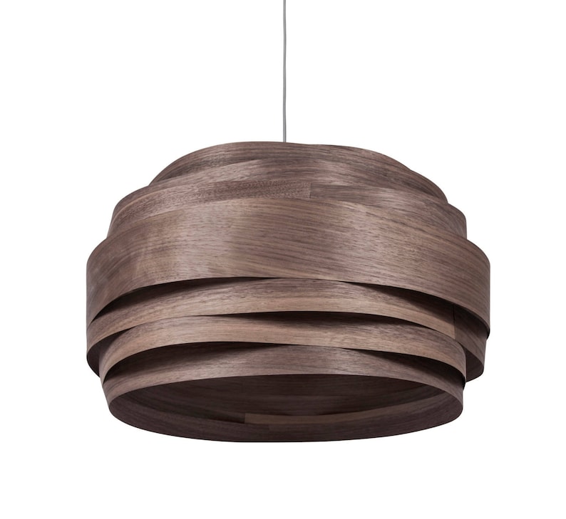 May include: A brown wooden pendant light with a layered, woven design. The light is suspended from a thin cord.