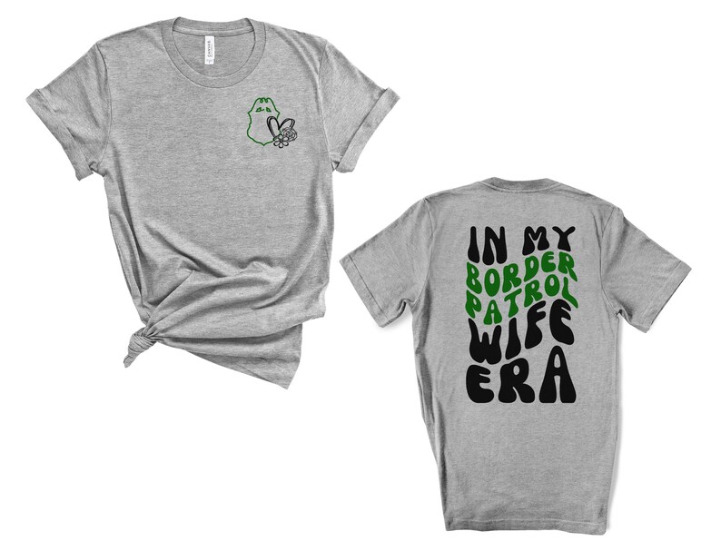 May include: Gray t-shirt with a green border patrol badge on the left chest and the text "In My Border Patrol Wife Era" in black and green on the back.