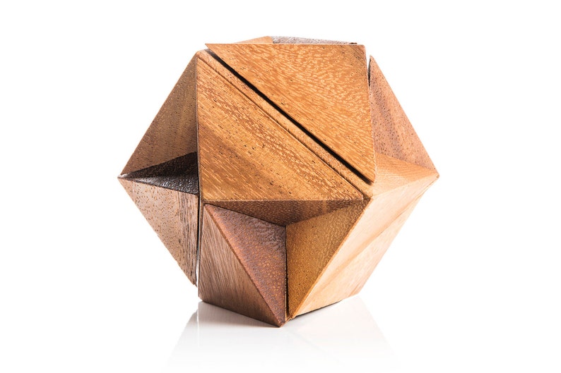 May include: A wooden geometric puzzle in the shape of a star. The puzzle is made of multiple pieces that fit together to form the star shape.