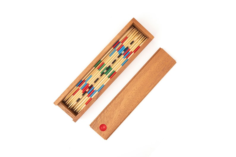 May include: A wooden box filled with colorful wooden sticks. The box is open and the sticks are arranged in a pattern. The box is on a white background.