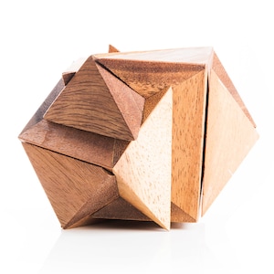 May include: A wooden puzzle made of interlocking triangular pieces. The puzzle is assembled into a geometric shape with a brown wood finish.