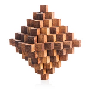 May include: A wooden puzzle made of many small, interlocking cubes. The puzzle is shaped like a diamond and is made of a light brown wood.