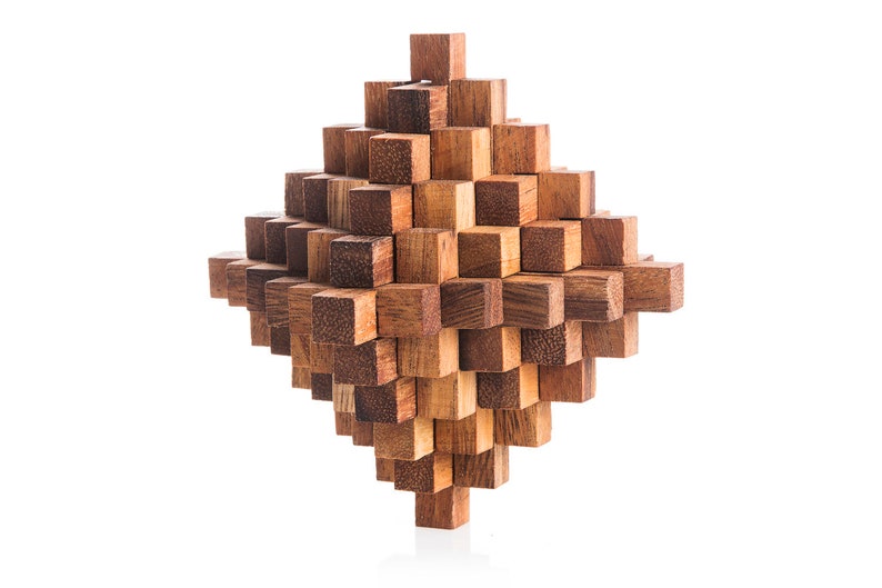 May include: A wooden puzzle made of many small, interlocking cubes. The puzzle is shaped like a diamond and is made of a light brown wood.