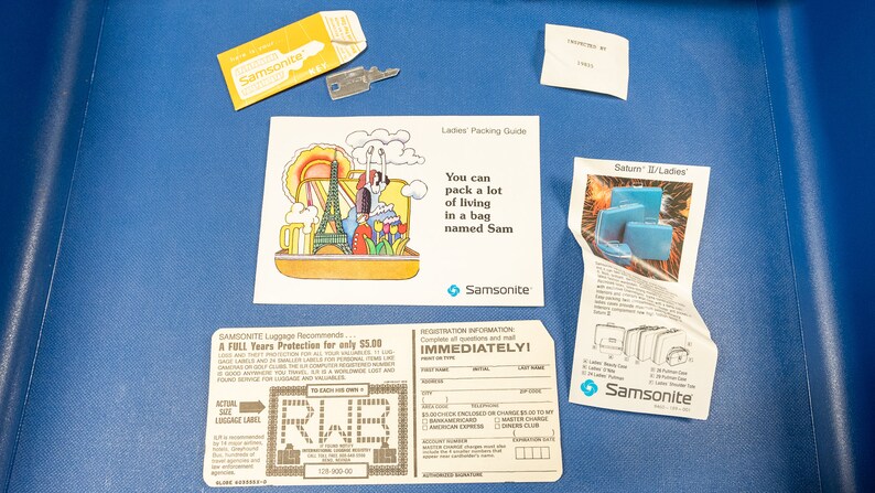 May include: A vintage Samsonite luggage tag with a registration form and a luggage protection plan. The tag is brown with white text and a blue Samsonite logo. The text on the tag reads "Samsonite Luggage Recommends... A FULL Tears Protection for only $5.00... REGISTRATION INFORMATION IMMEDIATELY!"