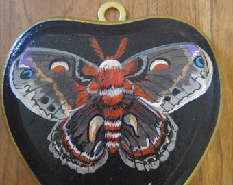 Moth hand painted on heart shaped wood piece