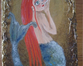 Red haired mermaid blowing bubbles. Hand painted on gold wood with textured edges