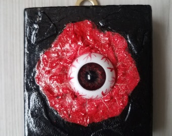 Bloody eyeball 2D art piece on reclaimed wood