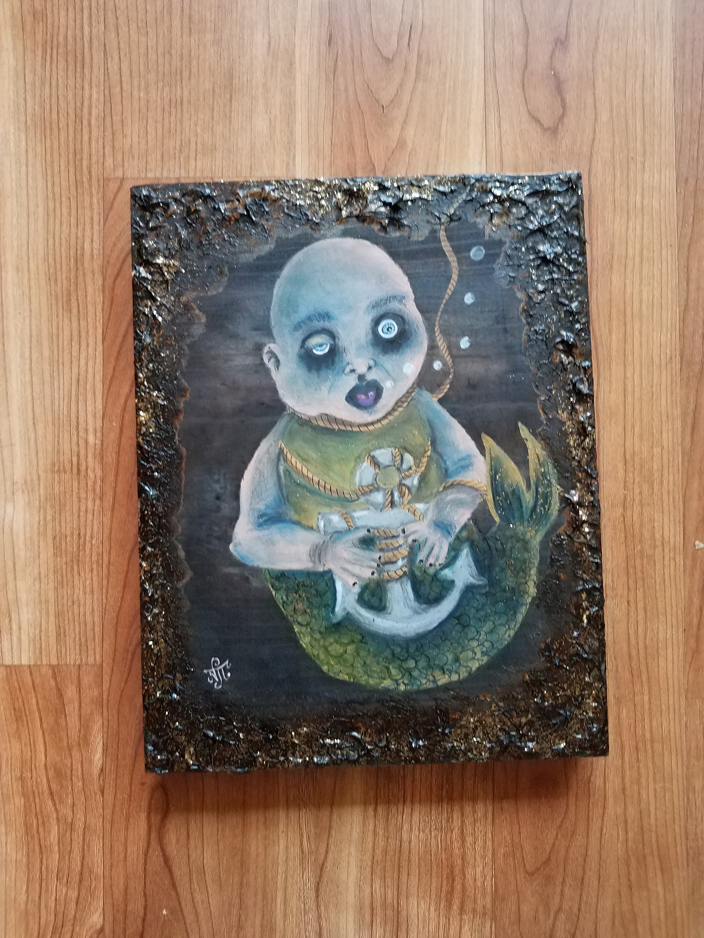 Creepy drowning doll mermaid with anchor. Oil a.d ink on textured sepia stained reclaimed wood piece