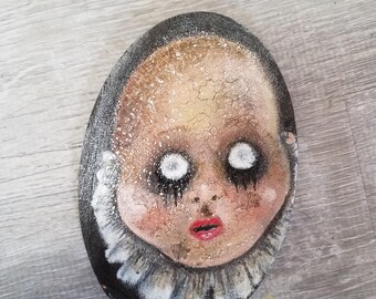 Fear, creepy old cracked doll head with dead eyes. Hand painted on oval wood piece