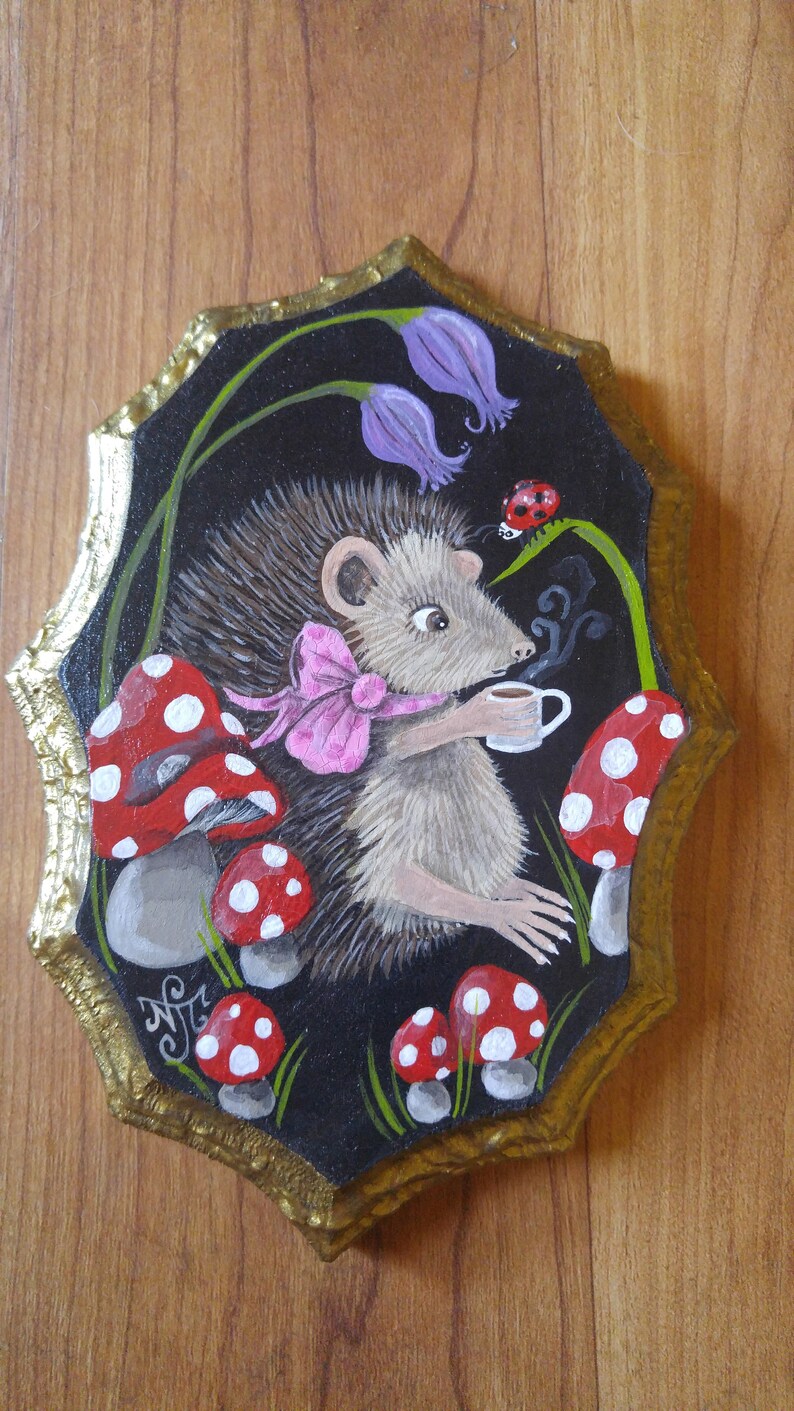 Hedgehog drinking a cup of tea sitting amongst magic mushrooms and bluebells Hand painted on decorative wood piece