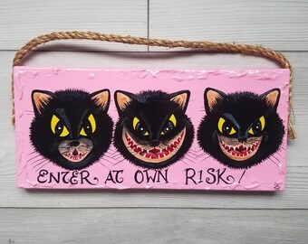 Scary cat faces hand painted on bright pink wood "Enter at own risk" hanging sigb