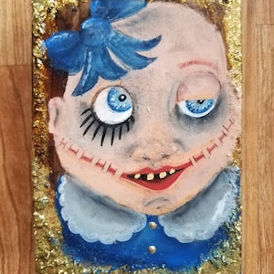 Little boy blue&quot; creepy vintage doll face with split mouth, hand painted on reclaimed wood with textured glitter edging