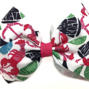 May include: A white hair bow with a red centre and a nautical themed print. The print features red lobsters, anchors, and the text "Rock My Boat".