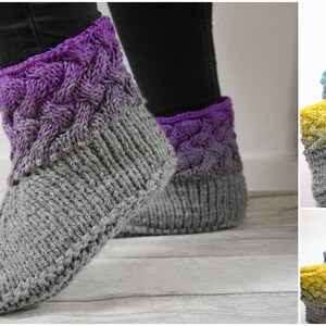 May include: Knitted slipper socks in various colors with a cable knit pattern on the cuff. The socks are gray with a gradient color on the cuff.