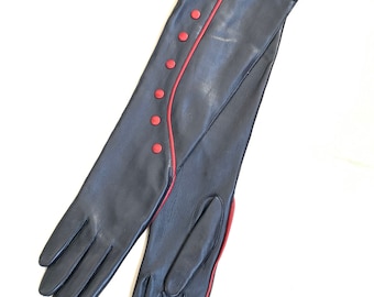 May include: A pair of long black leather gloves with red stitching and red buttons down the back of the hand.