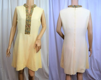 Vintage 1960s off white sleeveless princess cut dress with heavily embellished neckline and center front trim