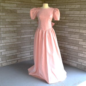 Vintage 1980s 1990s apricot jewel neckline with V back and full basque waist skirt accented with butterfly bow