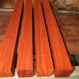 May include: Four pieces of reddish-brown wood, each about 12 inches long and 4 inches wide, with a smooth, polished surface.
