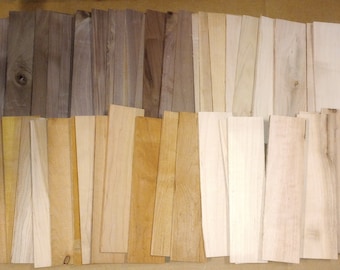 May include: A collection of rectangular wooden planks in various shades of brown and tan. The planks are arranged in a neat, organized manner, showcasing the natural grain and color variations of the wood. The image highlights the different types of wood.