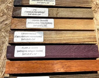 May include: Close-up of ten different wood samples, each labelled with the common and scientific name of the wood species. The samples are arranged vertically, with the top sample being Macacawood (Platymiscium ulei) and the bottom sample being Picana Negra (Cordia alliodora). Each sample is 3/4 inch by 3/4 inch by 24 inches.