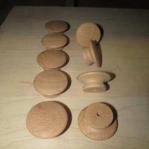 May include: Ten unfinished wooden knobs with a smooth, natural finish. The knobs are round and have a small hole in the center for attaching to furniture.